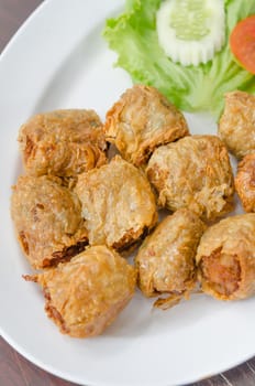 top view deep fried crab meat roll cake on white dish , chinese food