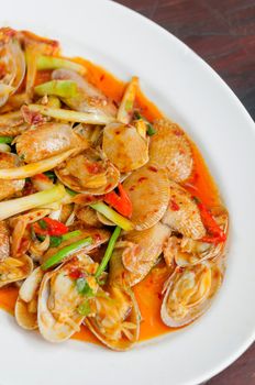 top view stir fried clams with roasted chili paste and thai basil leaves