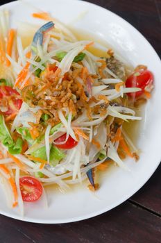 spicy papaya salad with crab on white dish , spicy food