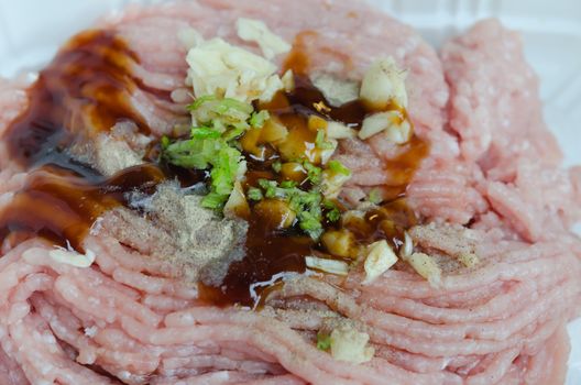 close up  raw ground beef with sauce and garlic
