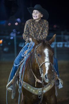 LOGANDALE , NEVADA - APRIL 10 : Cowboy Participating in a Calf roping Competition at the Clark County Fair and Rodeo a Professional Rodeo held in Logandale Nevada , USA on April 10 2014