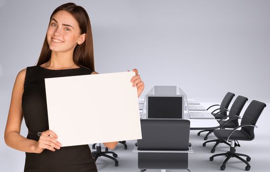 Businesswoman holding paper sheet. Conference table, chairs and laptops as backdrop