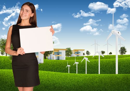 Businesswoman holding paper sheet. Blue sky, green grass and town as backdrop