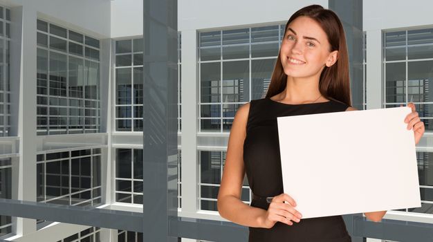 Businesswoman holding paper sheet. Large window as backdrop