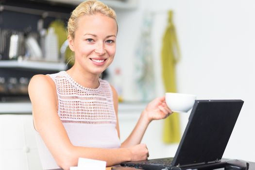 Happy business woman working from her home having more time for her family and her morning coffee.