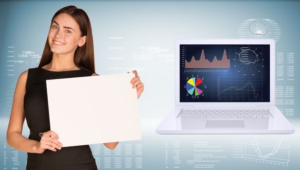 Businesswoman holding paper sheet. Open laptop with high-tech graphs  as backdrop