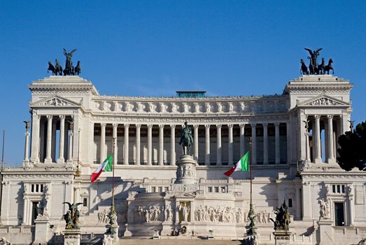 Photo shows Rome cityscape with houses and roofs.