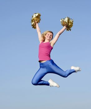  laughing young blond cheerleader jumping
