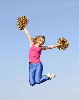  laughing young blond cheerleader jumping