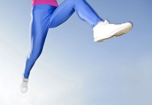 woman legs jogging, blue background