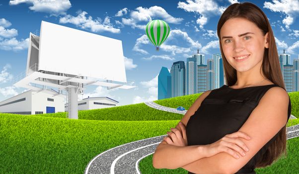 Businesswoman with blank billboard, road, skyscrapers and industrial area as backdrop