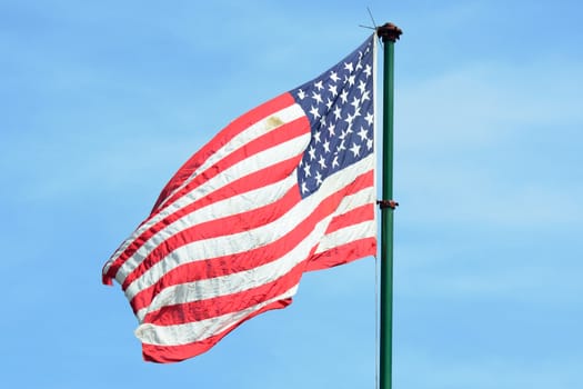 American flag flying in Blue sky