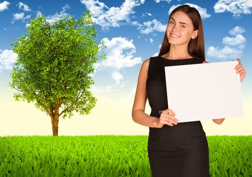 Businesswoman hold white paper. Tree and green landscape as backdrop