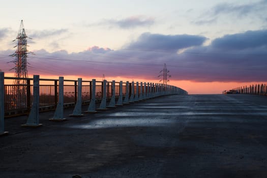 Straight road and colorful dawn - Stock Image