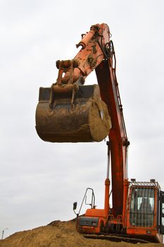 Orange excavator at construction site - Stock Image