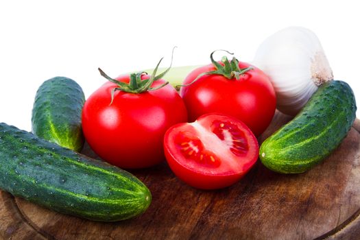 Cucumbers, tomatoes and garlic isolated on white