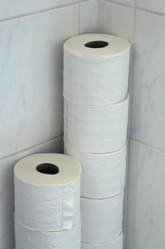 Pile of toilet papers against wall in restroom