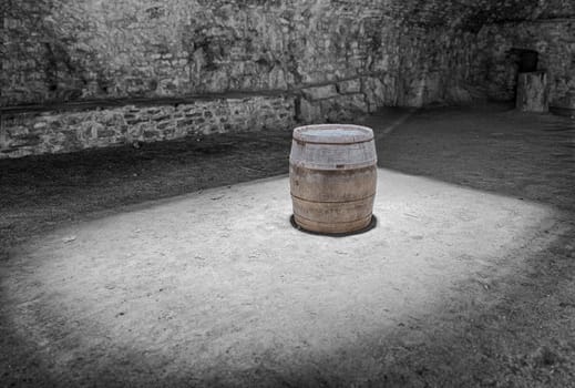 Wine barrel under a sunlight in a cellar.