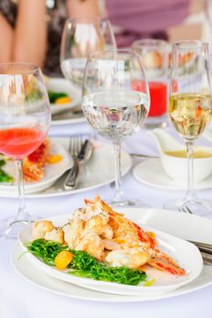 Prepared lobster and sea weed served on plates