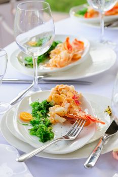 Prepared lobster and sea weed served on plates