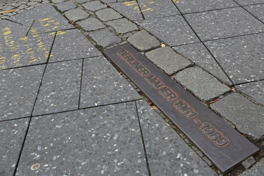 Sign on the road to show the place of the old Berlin Wall