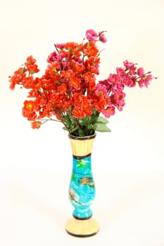 artistic vase with flowers on white background