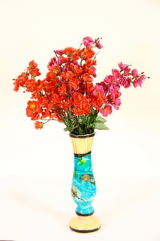 artistic vase with flowers on white background