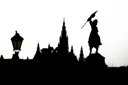Vienna cityscape silhouette with monument dedicated to Archduke Charles of Austria (Erzherzog Karl) ridding a horse and the city hall (Rathause) in Vienna, Austria.