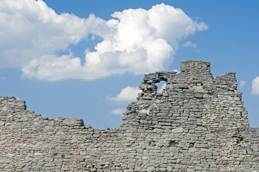 Ruins of old fortress wall and cloudy sky