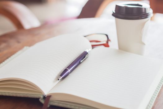 Notebook and pen with coffee cup, stock photo