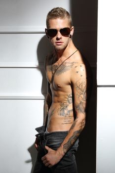 Handsome tattooed Caucasian man without a shirt