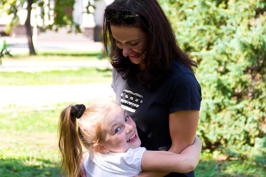 Photo of smiling playing mother and daughter