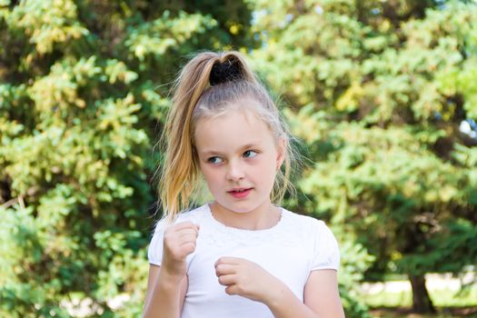 Cute girl with blond long hair and blue eyes