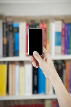 blank screen smartphone in woman hands at library