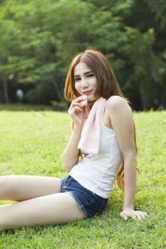 Woman sitting rest after exercise Inside the park