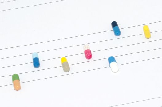 Various capsules on stave paper