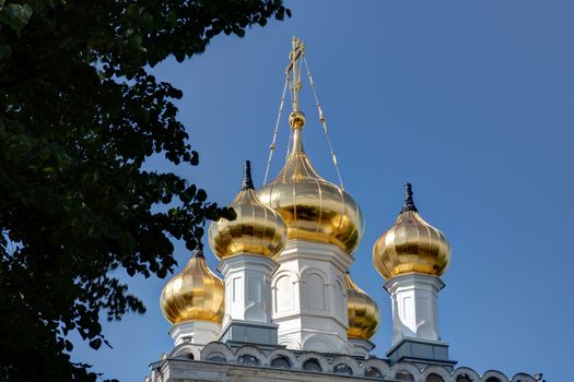 Orthodox Church goldem domes against blue sky