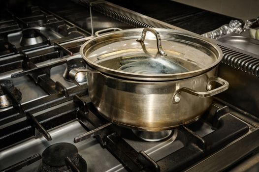 real dirty restaurant kitchen, pot on stove