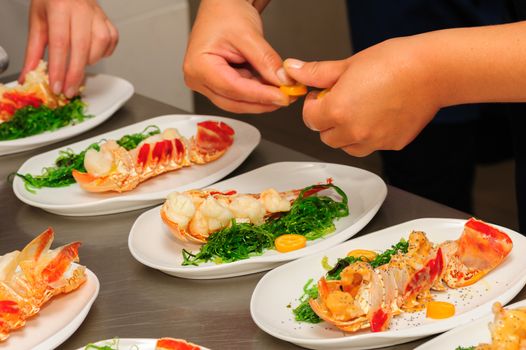 Serving and decorating of prepared lobsters on plates