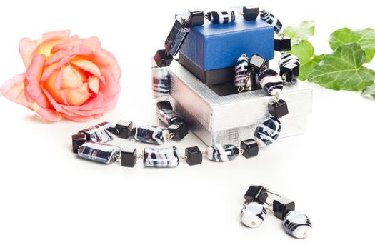 black and white necklace on jewelry box with earrings