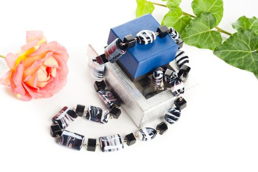 black and white necklace on jewelry box with earrings