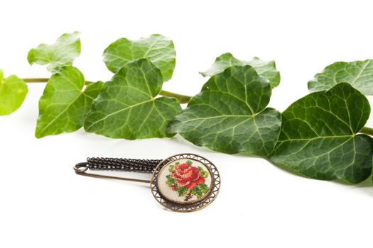 vintage fashion brooch with rose design and green leafs