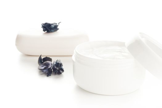 white cosmetic moisturizer cream in white container and white soap