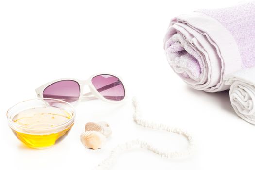 wellness spa massage oil, towels white necklace and sun glass