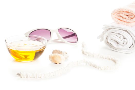 wellness spa massage oil, towels white necklace and sun glass
