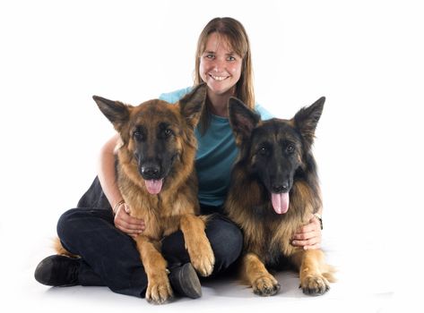 woman and dogs in front of white background