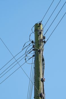 wooden telegraph pole with telephone wires connected