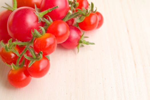 Photo shows a detail of the colourful tomatoes on a table.