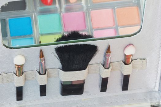 Multicolored eye shadows with cosmetics brush. Eyeshadow makeup palette. Colorful eye shadow make up.