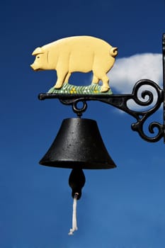 Bell with piglet on blue sky